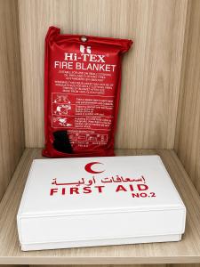 a box of fire blanket next to a red packet at أرياف سويت in Al Baha +1 photo