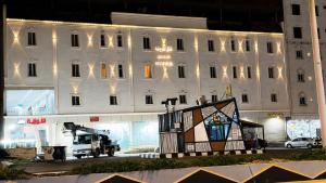 a large white building with a painting in front of it at أرياف سويت in Al Baha