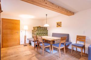 a dining room with a wooden table and chairs at Vitalhof am Kreischberg by ALPS RESORTS in Bodendorf +27 photos