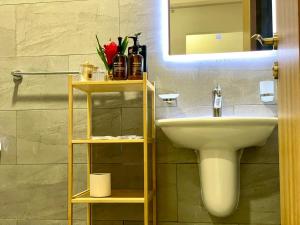 a bathroom with a sink and a mirror at Mabaat-Executive 3BR- Sama Jeddah 609 in Jeddah +22 photos