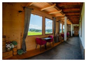 a room with a table and chairs and a window at Willa na Borku in Ciche