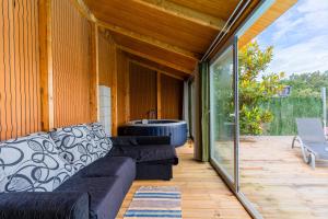 a screened in porch with a couch and a tub at Casa entre Rios in Alpendurada +35 photos