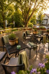 a group of tables and chairs on a patio at Plaza Hotel Gyula in Gyula
