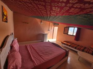 a bedroom with a bed with a red ceiling at Terre d'Océan in Taghazout +67 photos