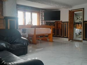 a living room with a table and a couch at Stary Bór in Murzasichle +25 photos