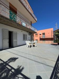 a patio with chairs and a table on a building at Mare e Monti a 5 minuti dal mare in Furnari