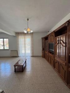 a living room with a tv and a coffee table at Mare e Monti a 5 minuti dal mare in Furnari