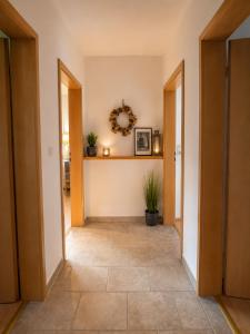 a hallway with two doors and a tile floor at Messeappartementhaus Bockenem direkt an der A7 in Bockenem +5 photos