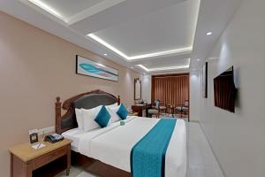 a hotel room with a bed and a dining room at Hotel Suba Palace Near Gateway of India in Mumbai