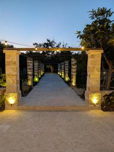 an archway with lights on it at night at NUX Rooms & Garden in Veglie +6 photos