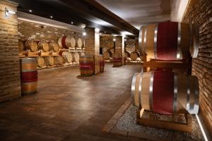 a room with wine barrels and a brick wall at Montalbera Wine Suites in Montemagno