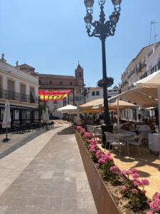 a street with tables and chairs and a street light at Hotel Alandalus in Torrox