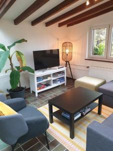 a living room with a tv and a coffee table at Chalet Ritz Ferienhaus in Dieblich
