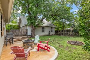 a yard with a fire pit and chairs and a house at Beverly Haus in Fredericksburg +20 photos