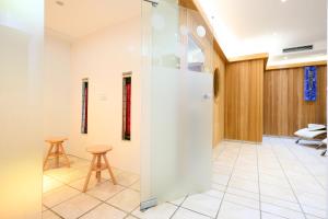 a room with two stools and a glass wall at Alpina`s Beds & Boots in Obertauern +33 photos