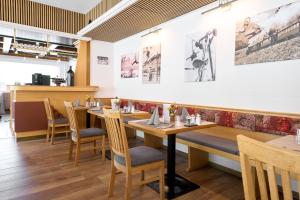 a dining room with wooden tables and chairs at Alpina`s Beds & Boots in Obertauern