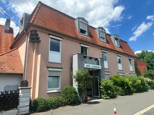 a pink building with a sign on the front of it at Hotel Lachnerhof in Erlangen