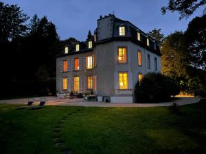 a large house at night with its lights on at LA LANDE in Pleyber-Christ