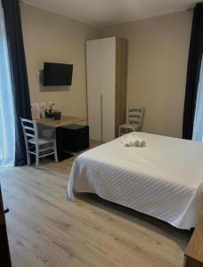 a bedroom with a bed and a desk and a computer at Locanda Terra dei Forti in Dolcè