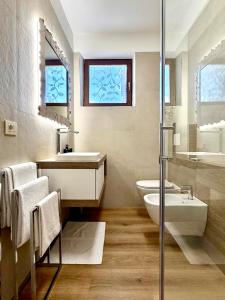 a bathroom with a sink and a toilet and a shower at Casa Cinzia in Gravedona +62 photos