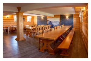 a dining room with wooden tables and chairs at Willa na Borku in Ciche