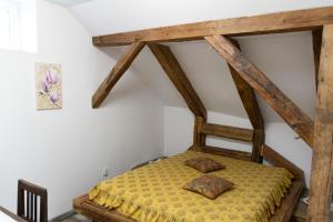a bed in a room with wooden beams at Casa Róza Vendégház in Sfântu-Gheorghe