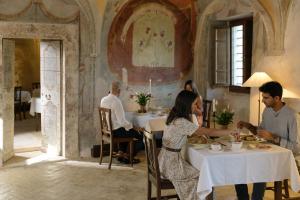 a group of people sitting at a table in a restaurant at Castel Di Luco - Authentic 11th-Century Castle in Acquasanta Terme