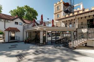 a large building with a staircase and a tower at Hotel Chateau Cojusna in Cojuşna