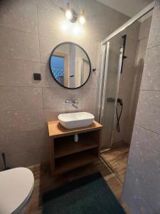 a bathroom with a sink and a mirror at Baracuda in Dębki