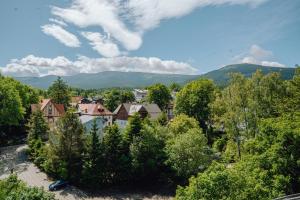 a town with trees and mountains in the background at Mariental Hotel & SPA in Szklarska Poręba