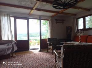 a bedroom with a bed and a room with a window at domek Kaszuby nad jeziorem in Chmielno