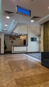 a large room with a lobby with a blue light at Miaad Al Majd Hotel in Mecca
