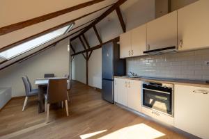 a kitchen with a table and a dining room at Casa Di Paolo in Sibiu