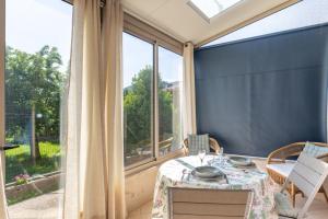 a dining room with a table and a large window at My Alba in Jaujac