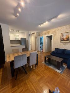 a living room with a table and a blue couch at Vanila Ub in Ub