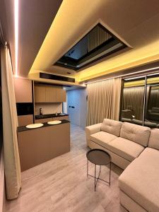 a living room with a couch and a table at Vila Summer Depo in Sarandë