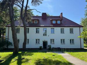 a large white house with a red roof at Rewita Mielno in Mielno