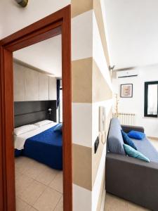 a bedroom with a bed and a sliding glass door at Hostpitaly - Il rifugio urbano in Chivasso