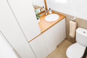 a bathroom with a sink and a toilet at Casa de vacances Els Arbocers in Cala Blanca +9 photos