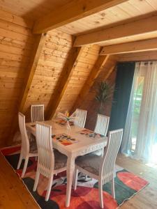 a dining room with a table and four chairs at Careva staza in Nikšić