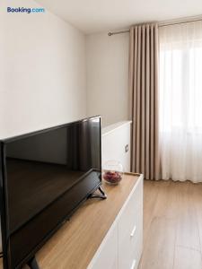 a living room with a large flat screen tv at Palazzo Solera Rooms in Casarano