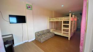 a small room with a bunk bed and a couch at Buku Island House in san juan la union +15 photos