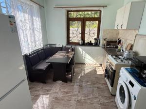 a kitchen with a table and a stove at Гостевой Дом на природе in Vanadzor