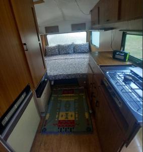 an interior view of an rv kitchen with a bed at kamp andrea in Šavnik