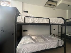 a couple of bunk beds in a room at Englishman Hostel Shkoder Backpackers Instant Sleep in Shkodër