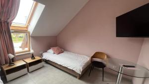 a small bedroom with a bed and a glass table at Pokoje Gościnne u Kovi in Legnica