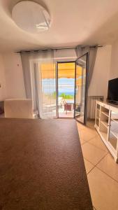 a living room with a view of the ocean at Glory Guest House Sea View in Mandaradoni
