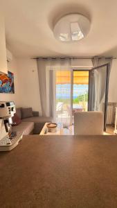 a living room with a couch and a table at Glory Guest House Sea View in Mandaradoni