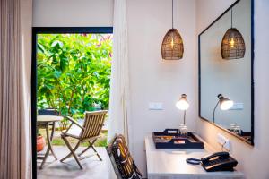a room with a desk and a table with a chair at Bakadaji Hotel in Serekunda