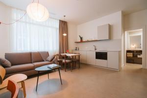 a living room with a couch and a table at Apartamentos Turísticos - ELBUZONROJO in Burgos +52 photos